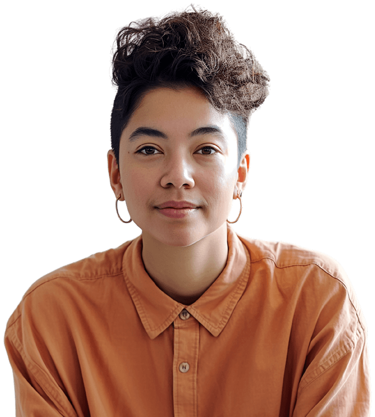 Person with short, curly hair and hoop earrings wearing an orange button-up shirt, smiling slightly against a plain background.